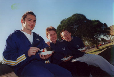 3 guys enjoying their cake